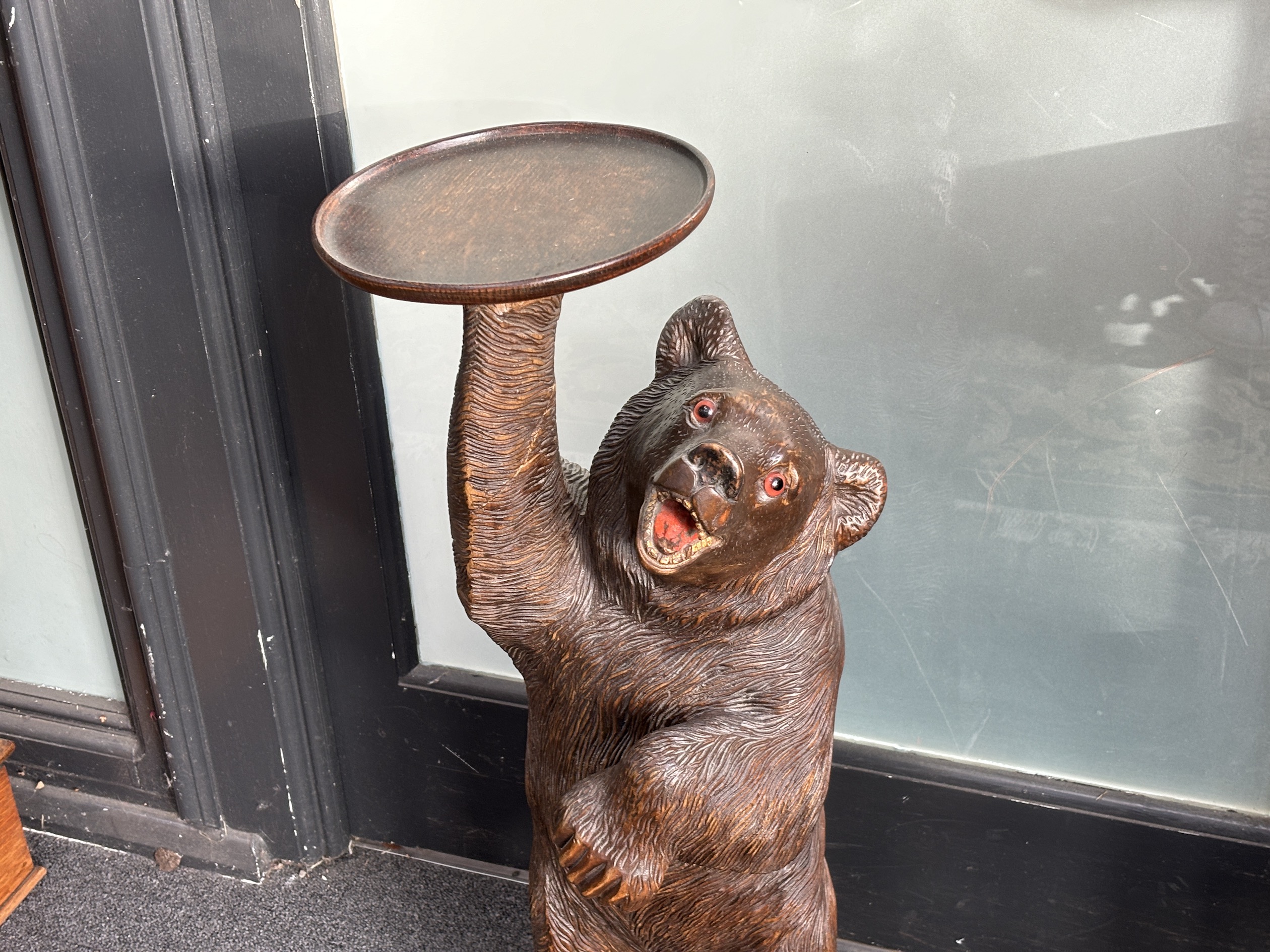 A large Black Forest figure of a bear, with later oak dish top, 71cm high